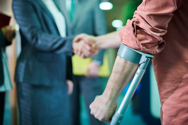 Injured client shaking hands with personal injury attorney