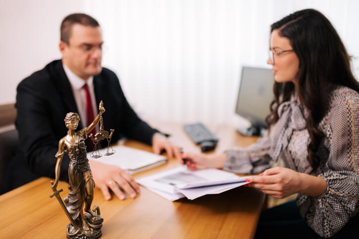Female client sitting with attorney