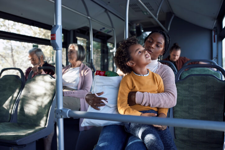 Mother and son sitting in a public bus
