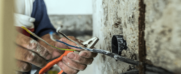 Electrician touching wires