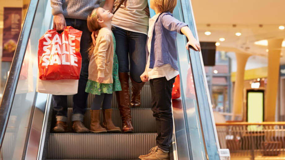A family walking down an escalator
