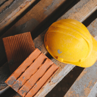 Hard hat and bricks on construction site