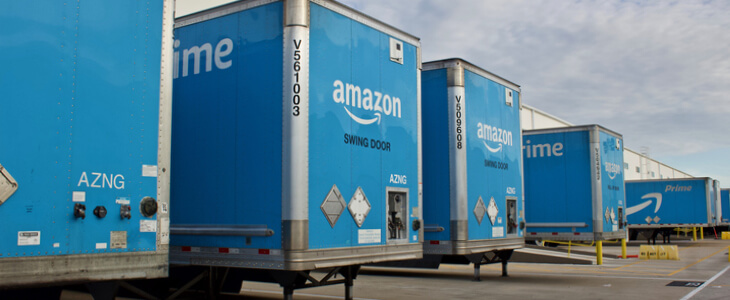 The distribution center for Amazon with commercial 18-wheelers parked.