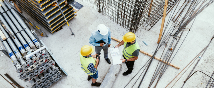 Construction workers on a construction site, discussing the plans