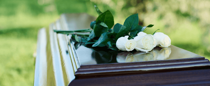 White roses on a casket, representing wrongful death