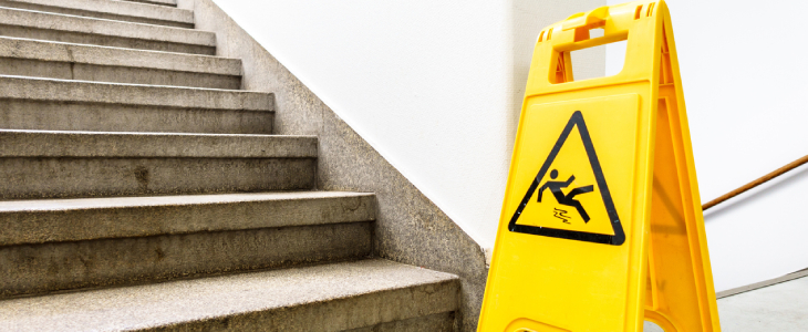 Caution wet floor sign at the bottom of the stairs
